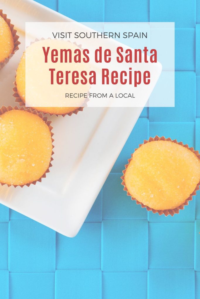 yemas on a white plate on a blue surface. On top it's written Yemas de Santa teresa recipe.