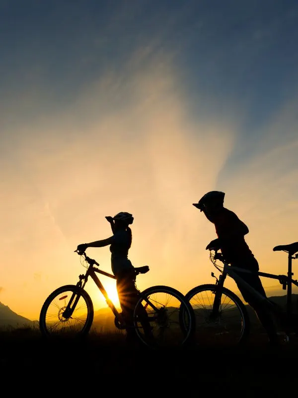 2 people looking into the sunset on their bikes. 20 Best Routes for Cycling in Andalucia in 2023