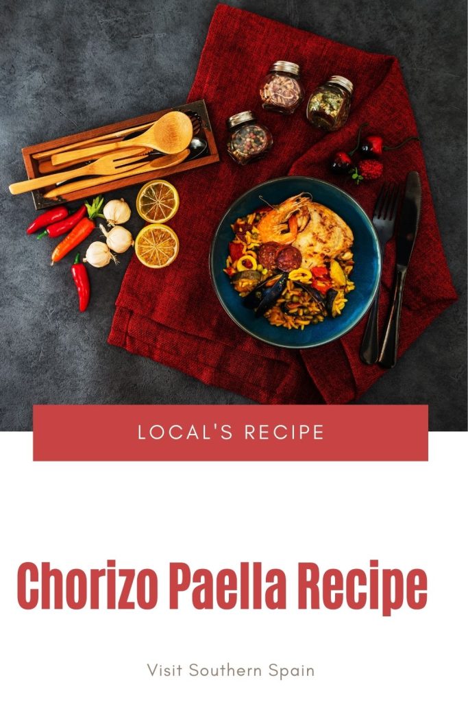 chorizo paella in a back bowl on a decorated table.  Under it's written Chorizo paella recipe. 