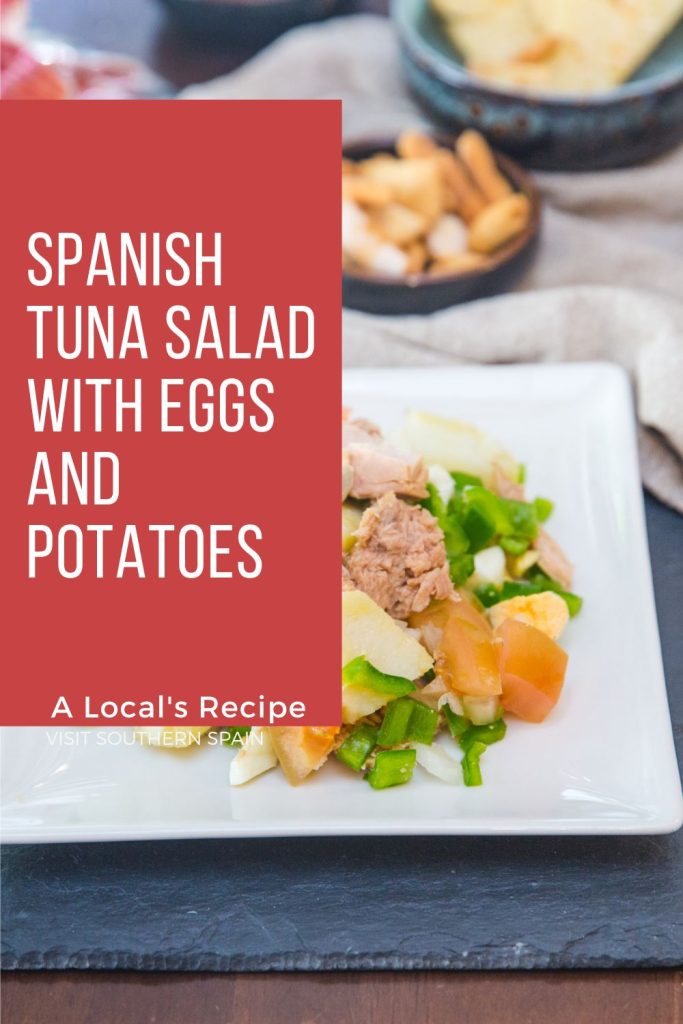 Tuna salad on a white plate. On the left it's written Spanish tuna salad with eggs and potatoes.