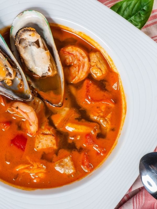 Spanish Seafood Soup in a white bowl. 25 Best Spanish Seafood Recipes to Try at Once!
