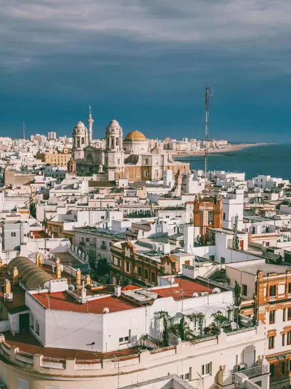 aerial view of Cadiz with a church and cathedral with a dome rooftop covered with white buildings