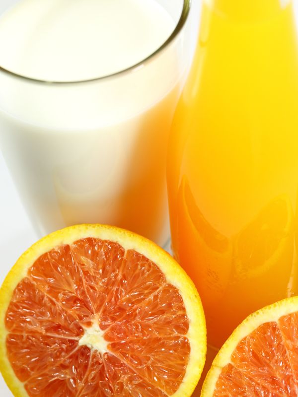 closeup with fresh orange juice and milk