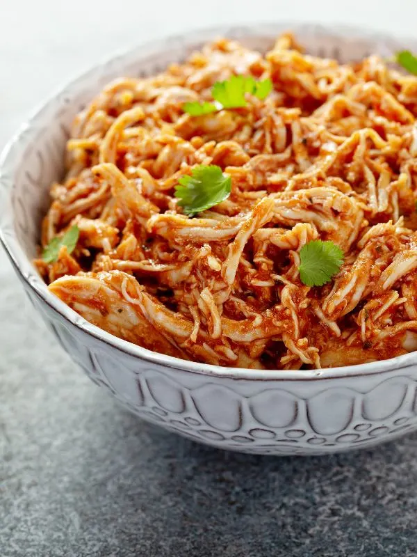 closeup with pulled meat in a bowl