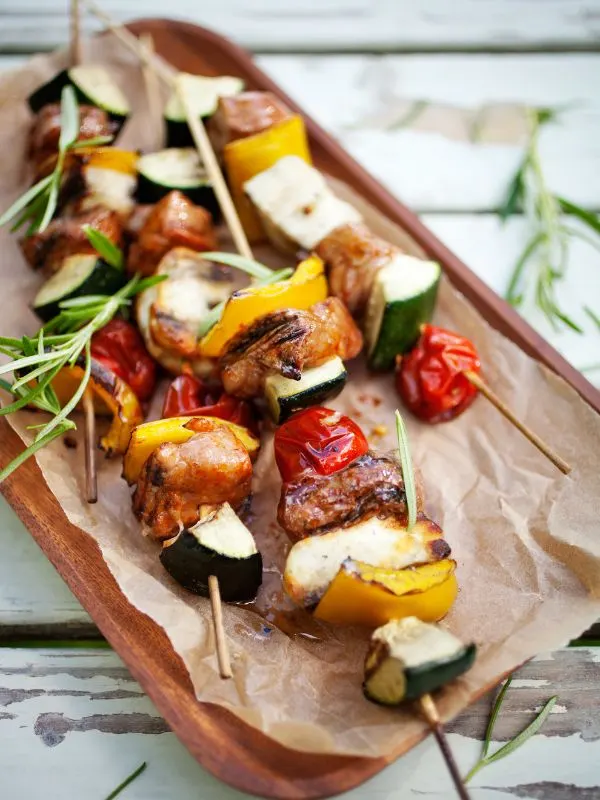 spanish chicken skewers with other vegetables. on a wooden board