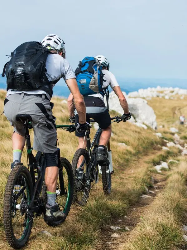 riders on e bikes riding through montes de malaga. 20 Best Routes for Cycling in Andalucia in 2023