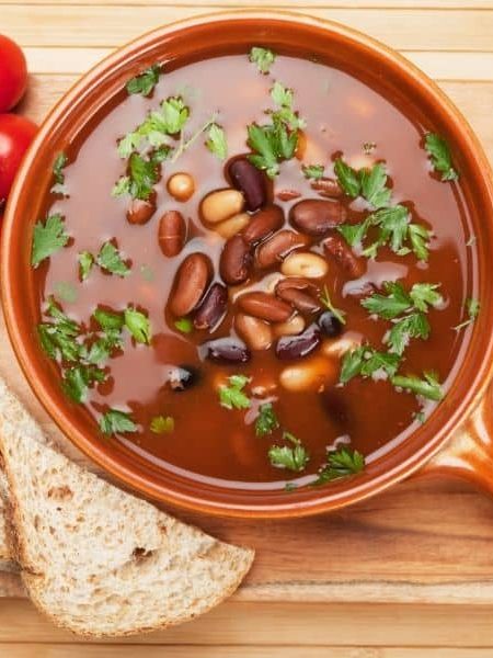 spanish bean tomato soup in a clay bowl