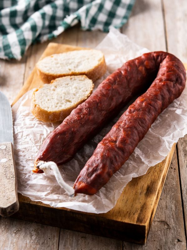 spanish chorizo on a wooden board for the cocido madrileno