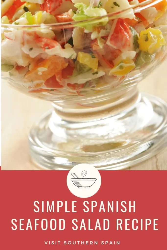 closeup with spansih seafood salad in a glass bowl. Under it's written Simple Spanish seafood salad recipe.