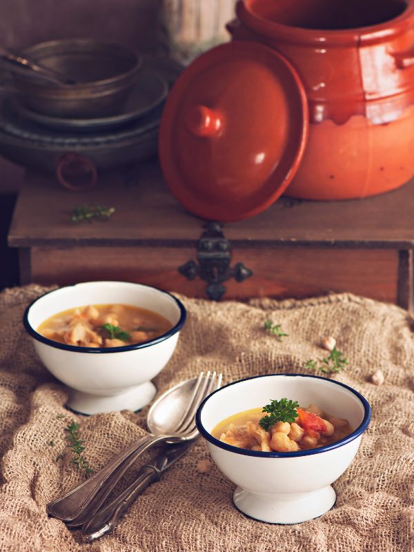 Potaje de Vigilia in 2 bowls with a rustic background - Easy Potaje de Vigilia Recipe