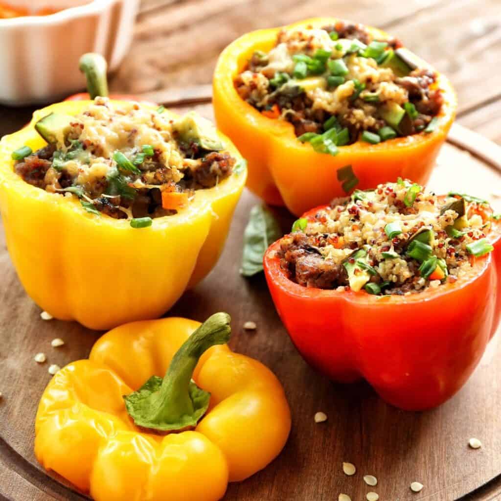 stuffed peppers with quinoa inside on a cutting board
