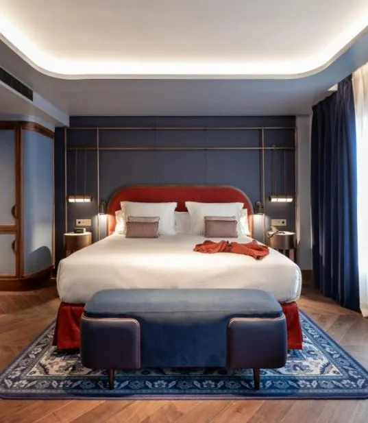 the interior bedroom of a Seda Club Hotel with shades of blue and red