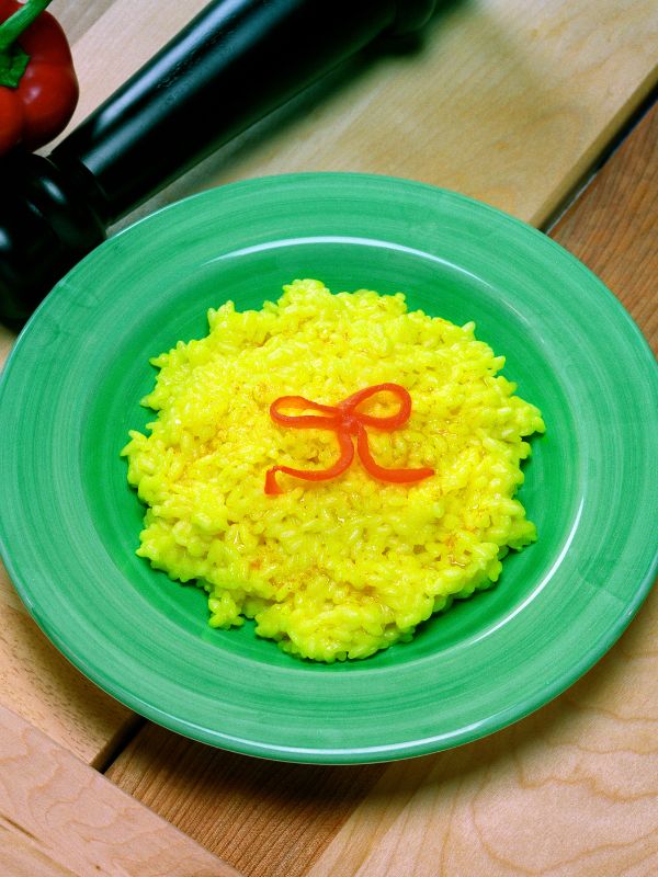 Spanish saffron rice in a green plate