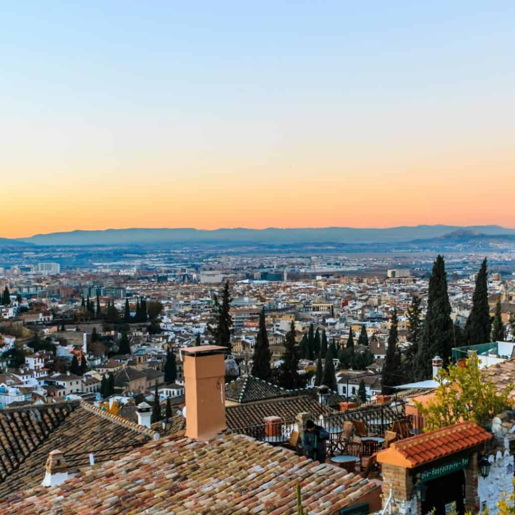 a view of Granada with a blue and orange from Mirador de San Nicolas