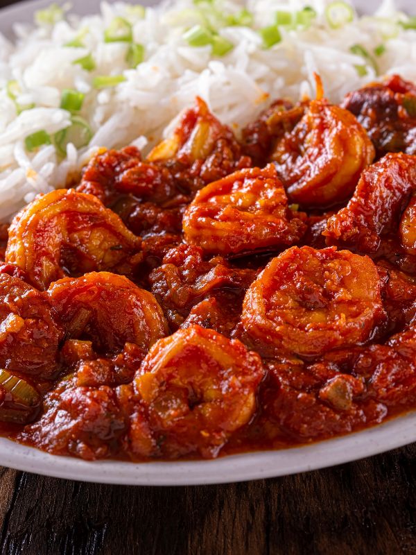 closeup with chorizo and shrimp next to some rice