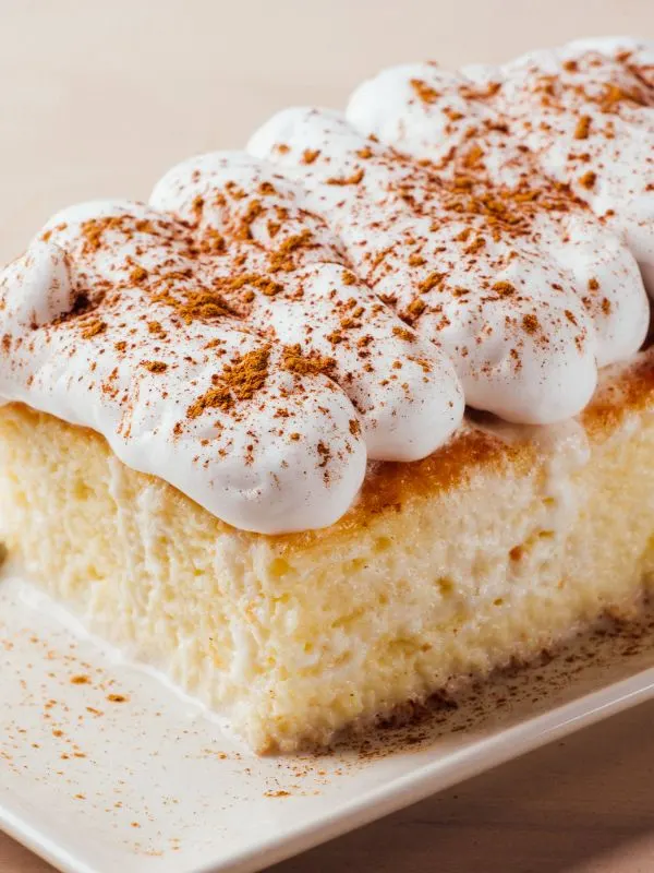 closeup with spanish milk cake on a white plate.