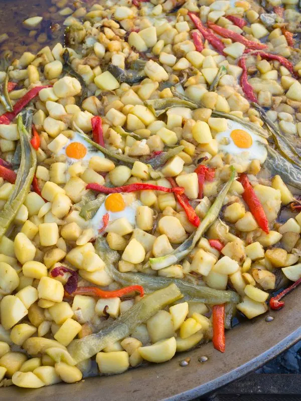 patatas a lo pobre in a big pan, a dish with potaoes and vegetables. 20 Best Spanish Vegetarian Tapas You Will Love