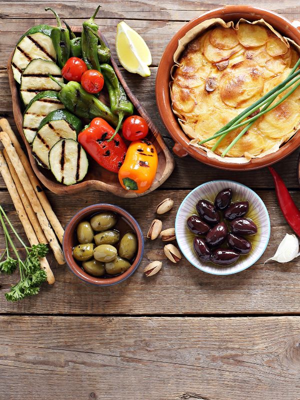 small selection of spanish vegetarian tapas on a wooden table. 20 Best Spanish Vegetarian Tapas You Will Love