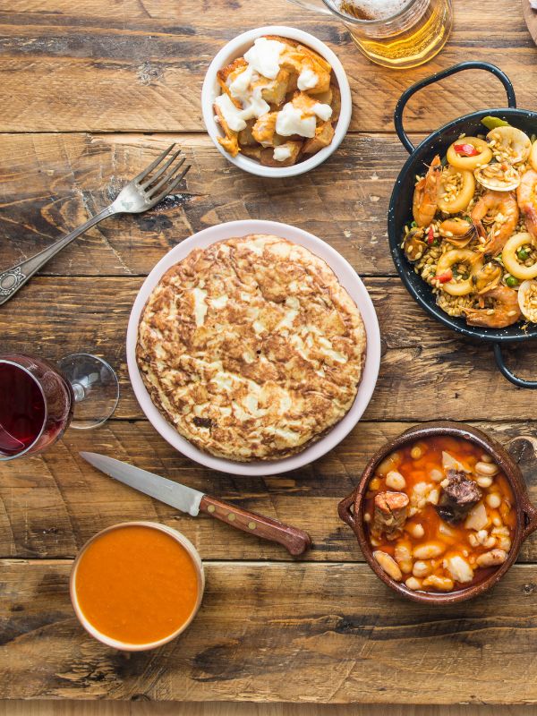 some of the best spanish recipe on a wooden table. 30 Best Spanish Recipes for Each Season