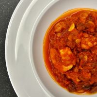 spanish chorizo and shrimp in a white plate