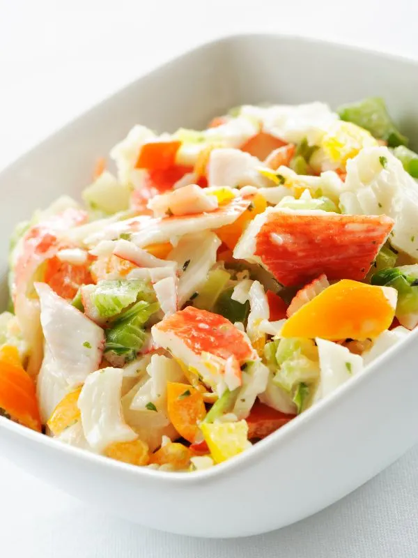 spanish seafood salad in a white bowl.