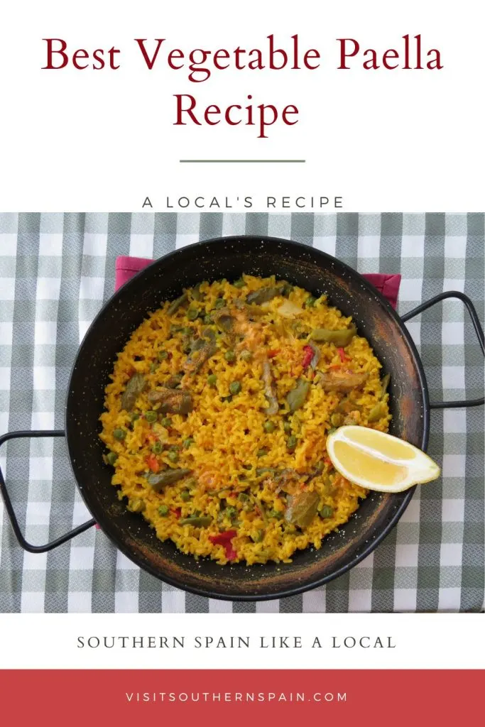 vegetable paella in a paella pan on a kitchen table. On top it's written best vegetable paella recipe.