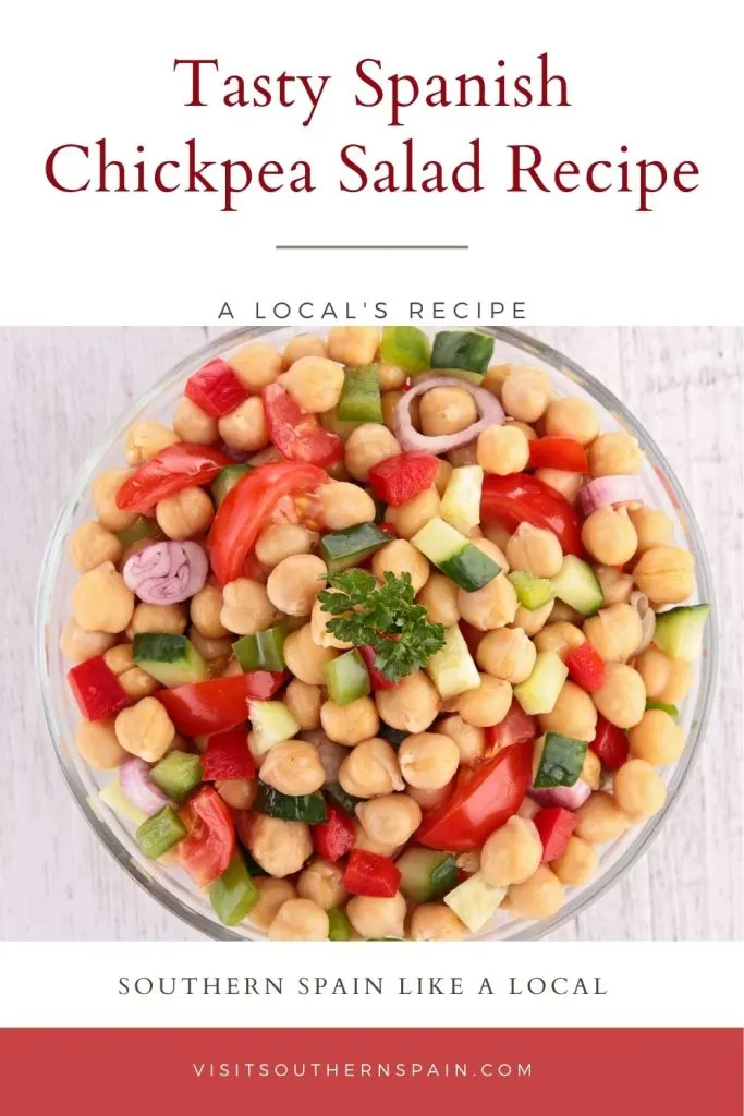 chickpea salad in a glass bowl. On top it's written tasty spanish chickpea salad recipe.