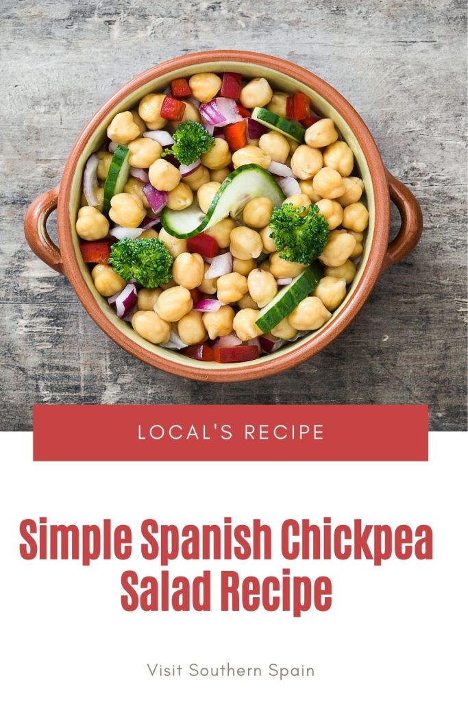 chickpea salad in a clay bowl. Under it's written simple spanish chickpea salad. recipe.