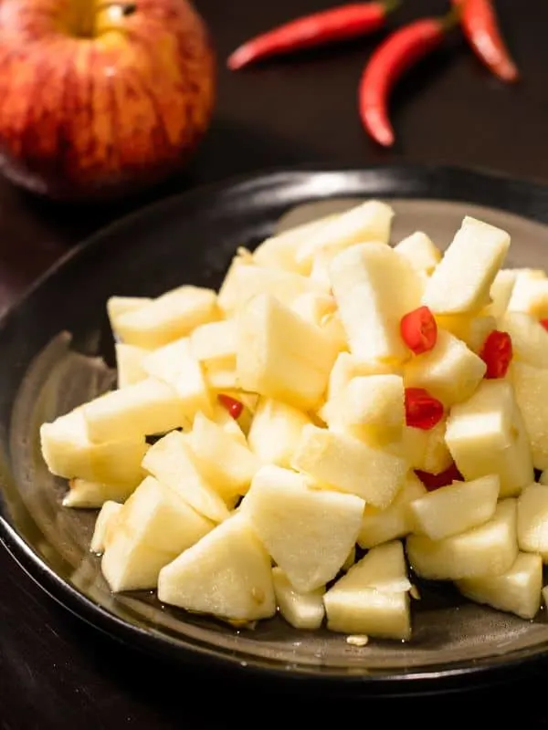 apple cheese salad on a black plate - Easy Apple Manchego Salad Recipe from Spain