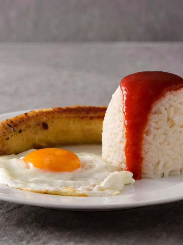 arroz a la cubana with rice, tomato sauce, eggs and bananas.
