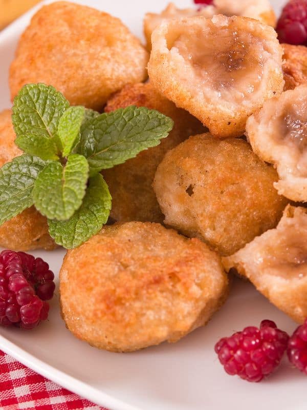 closeup with banana croquettes served with raspberry