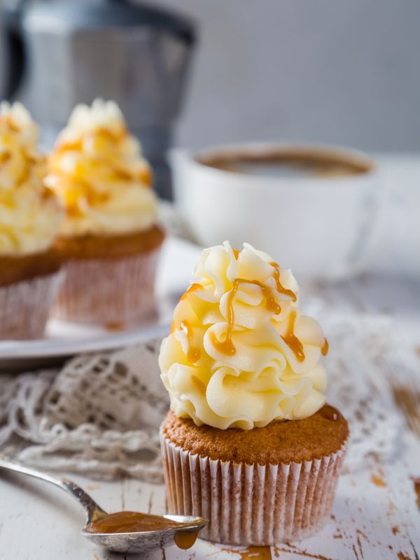 dulce de leche cupcake with dulce de leche frosting and rusting background.