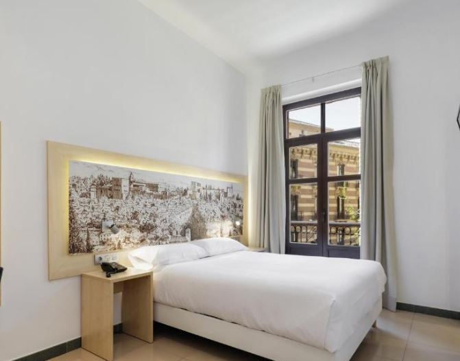 interior of a bedroom at Atenas Granada. 20 Best Cheap Hotels in Granada for 2023