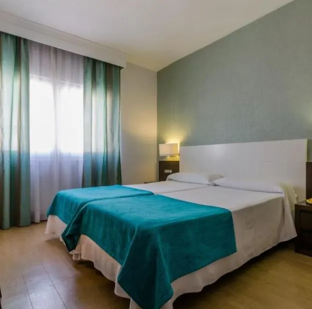 interior of a bedroom at Don Juan hotel in Granada. 20 Best Cheap Hotels in Granada for 2023