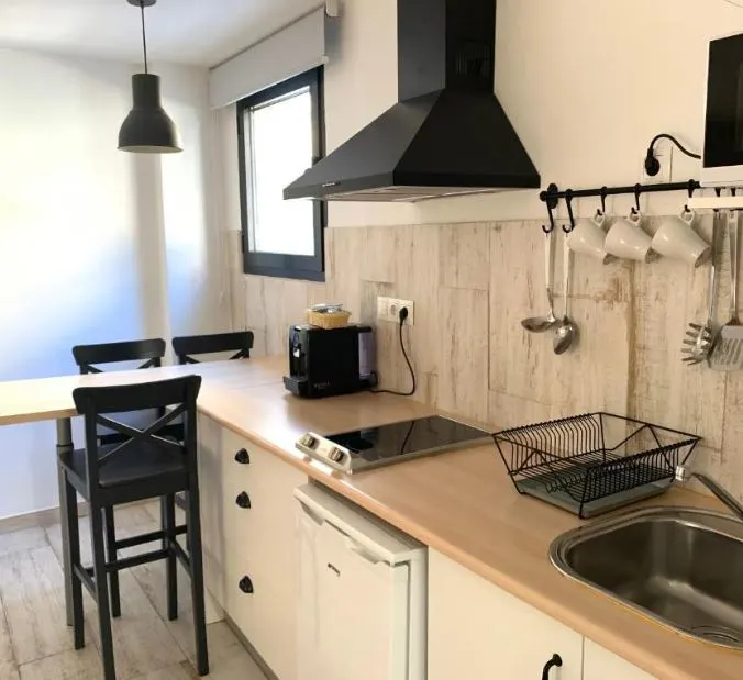 kitchen at Apartamentos GHM Gorbea Suites. 20 Best Cheap Hotels in Granada for 2023