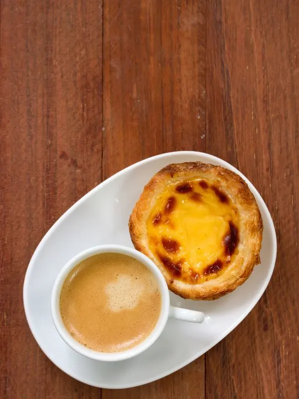spanish custard tart served with a cup coffee.