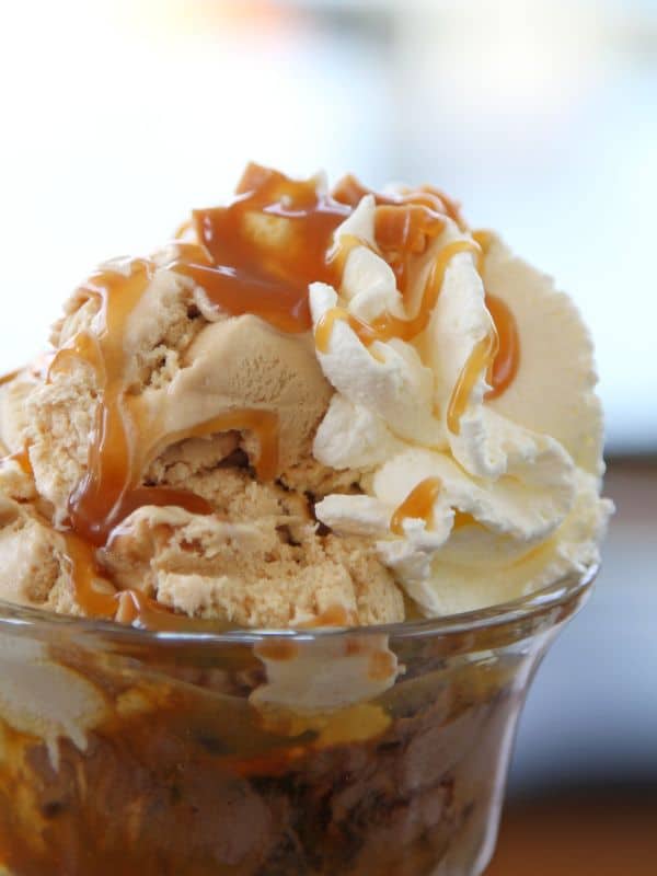 spanish ice cream served with caramel sauce and whipped cream