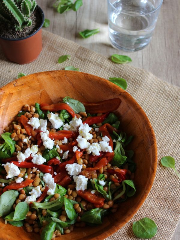 spanish lentil salad with feta cheese in a wooden bowl