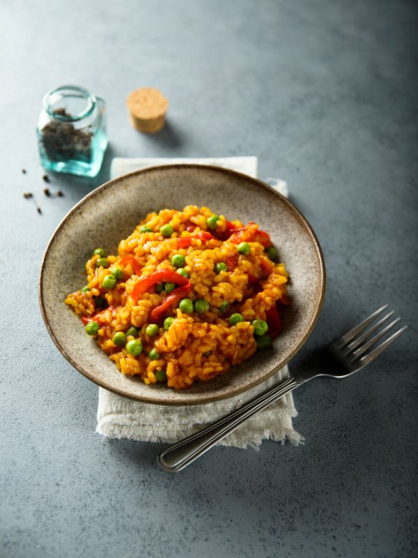 vegetable paella recipe in a bowl on a kitchen table. - Quick Vegetable Paella Recipe from Spain