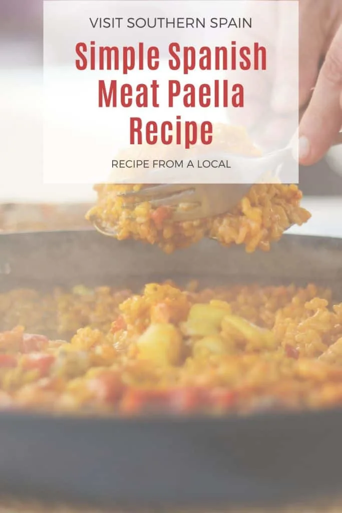 a pin with meat paella recipe served with a spoon.