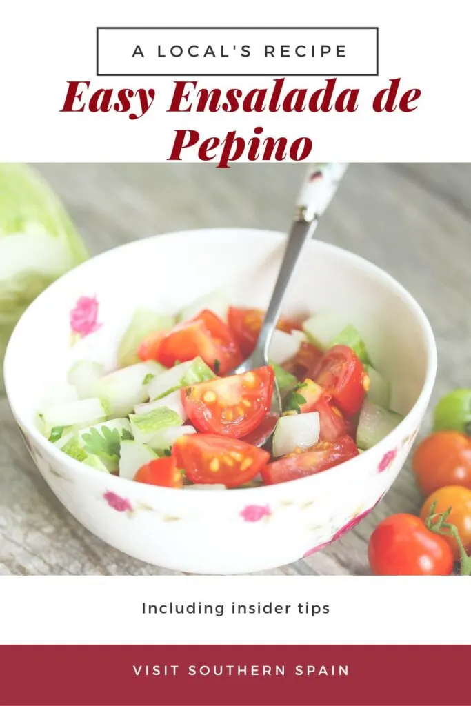 a pin with a bowl of ensalada de pepino with tomatoea and onion.