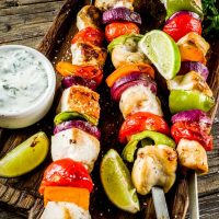 Spanish Chicken Skewers served on a wooden board.
