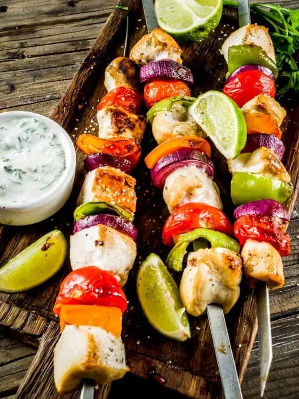 Spanish Chicken Skewers served on a wooden board. - Easy Spanish Chicken Skewers Recipe