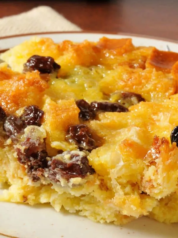 a slice of spanish bread pudding with raisins.