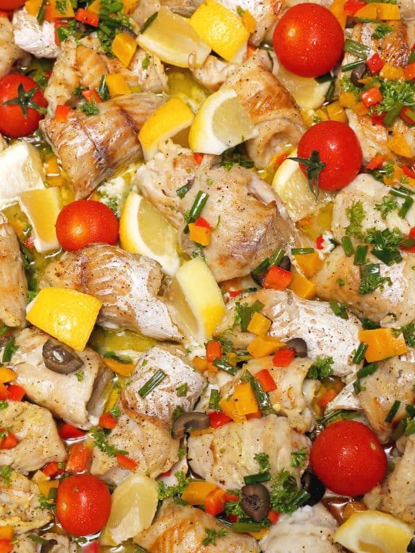 closeup with ensalada de bacalao with lemon, tomato and other vegetables