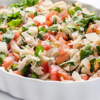 closeup with ensalada de bacalao with tomatoes and cod fish.