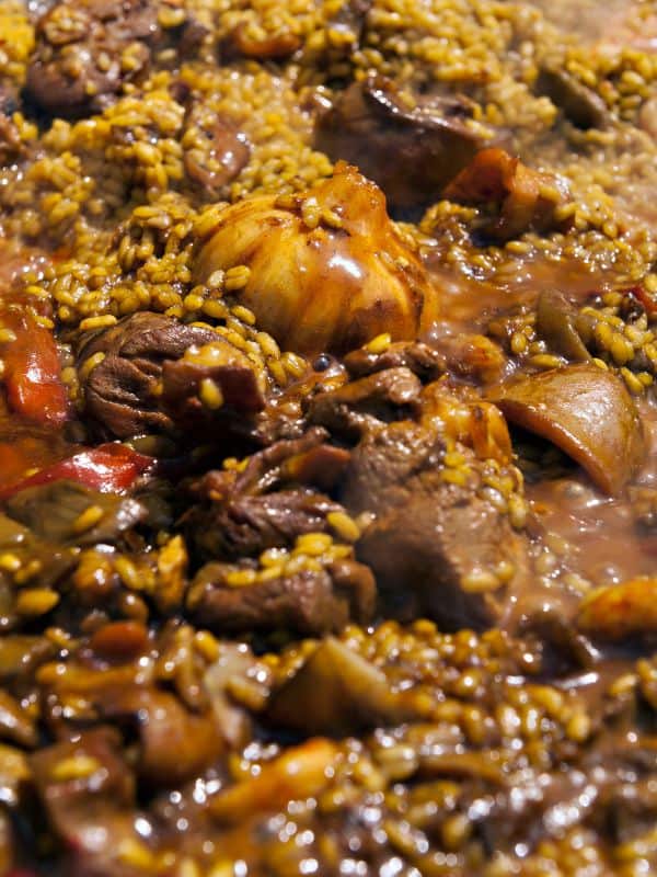closeup with meat paella recipe from spain with beef and rice