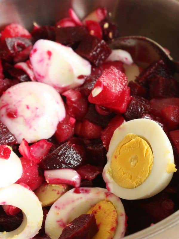 closeup with spanish potato salad with beets and eggs