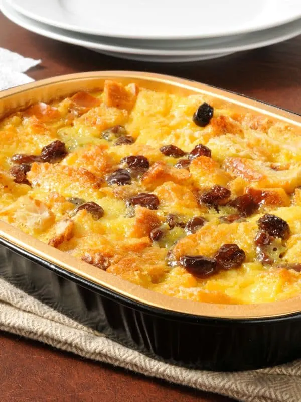 spanish bread pudding in a tray on a kitchen towel.