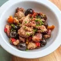 spanish octopus salad in a white bowl